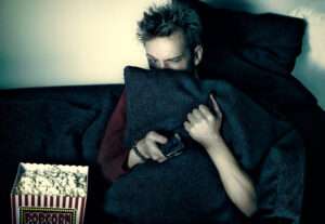 Man hides face behind pillow